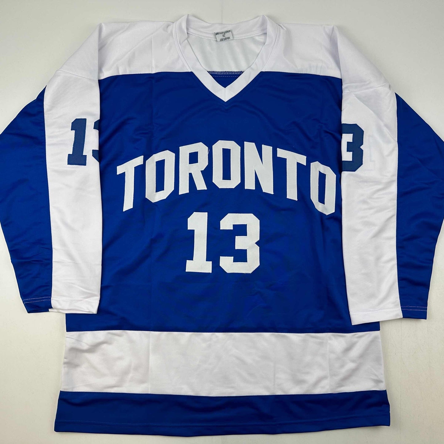 Blue and white Toronto hockey jersey with number 13 displayed flat against white background, front view.