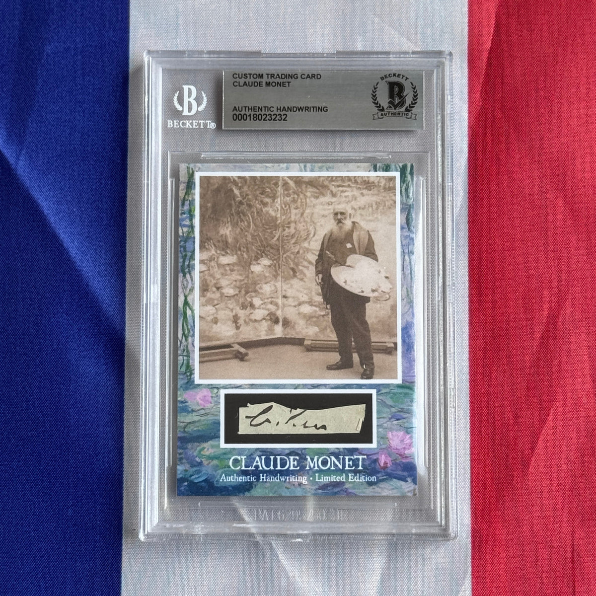 Front view of a Beckett-slabbed card on a tricolour flag, showing a sepia photo of a bearded man holding a palette.