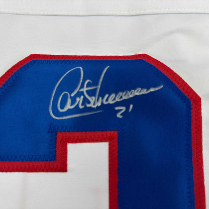 Close-up of autograph signed in silver pen on blue fabric of Montreal Canadiens hockey jersey with red trim.