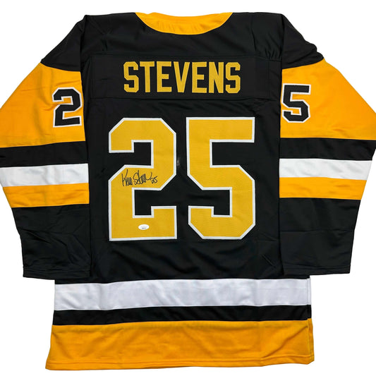 Back view of black and gold Pittsburgh Penguins hockey jersey number 25 with "STEVENS" nameplate and autograph.
