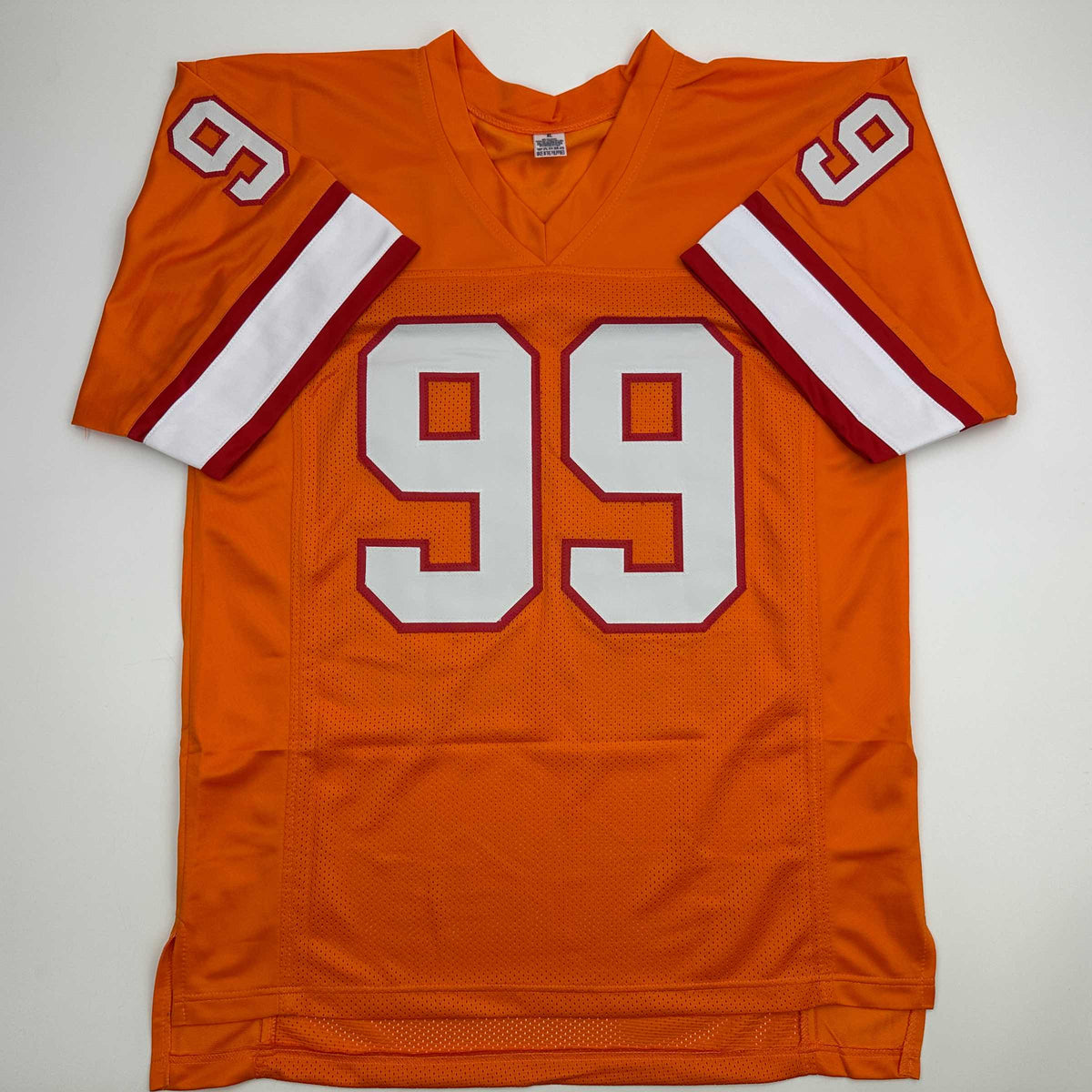 Front view of an orange mesh jersey laid flat on white, showing white red-outlined number 99 on the chest.