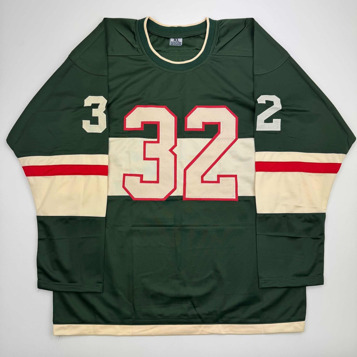 Front view of green and cream striped hockey jersey with red-outlined number 32 and shoulder numbers 3 and 2.