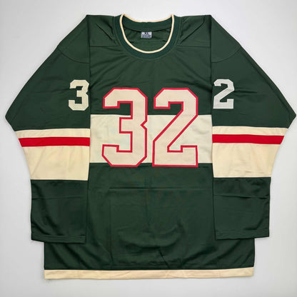 Front view of green and cream striped hockey jersey with red-outlined number 32 and shoulder numbers 3 and 2.