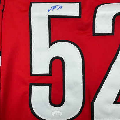 Close-up of white number 5 with black trim on red hockey jersey fabric, showing JSA authentication sticker below.