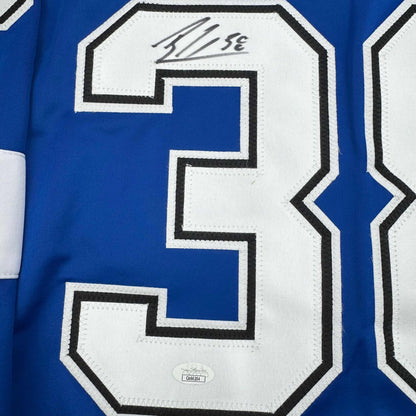 Close-up of blue hockey jersey number 3 with white and black stitching, showing autograph and JSA authentication hologram.