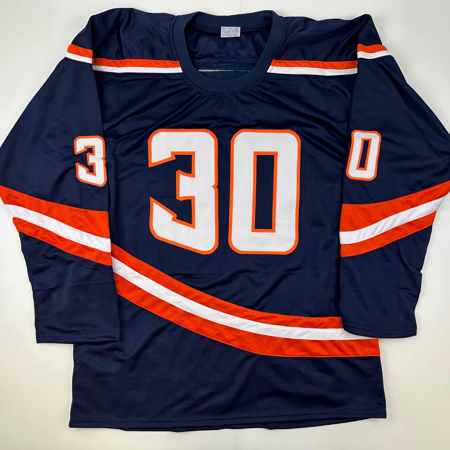 Navy blue hockey jersey with number 30 in orange and white, displayed flat from front view showing orange and white striped sleeves and chest design.