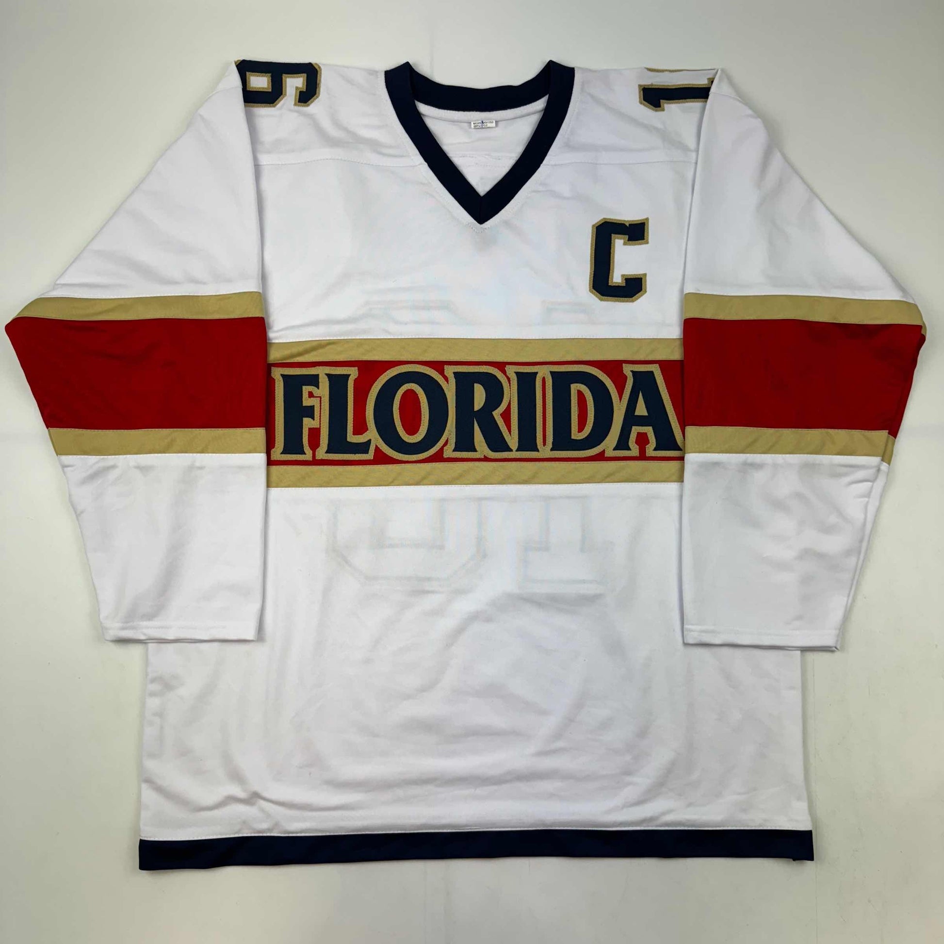 White Florida hockey jersey with red and gold horizontal stripes, displayed flat against gray background, front view.