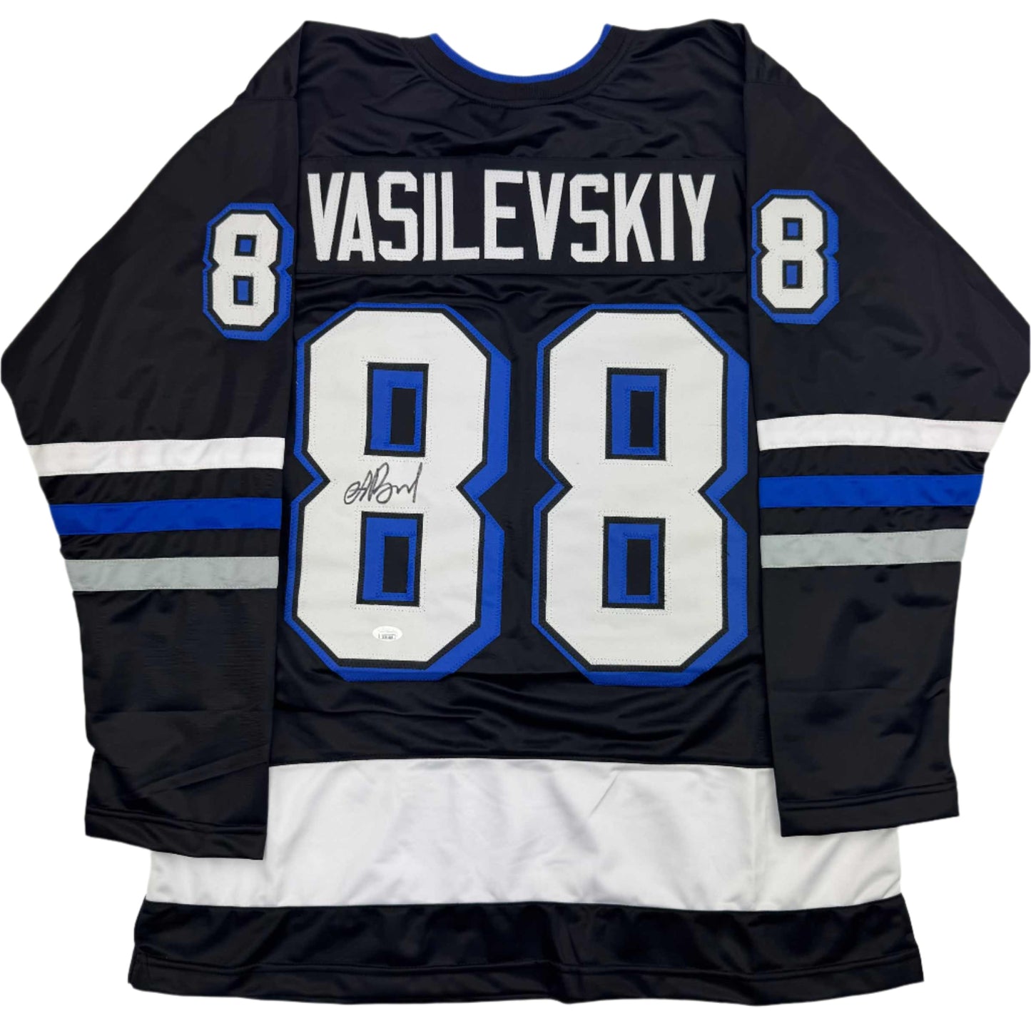 Back view of black hockey jersey with blue and white stripes, number 88, and "VASILEVSKIY" nameplate with autographed signature.