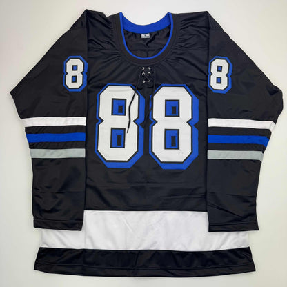 Black hockey jersey with blue and white trim displaying large number 88 on front and smaller number 8 on shoulders, flat lay view.