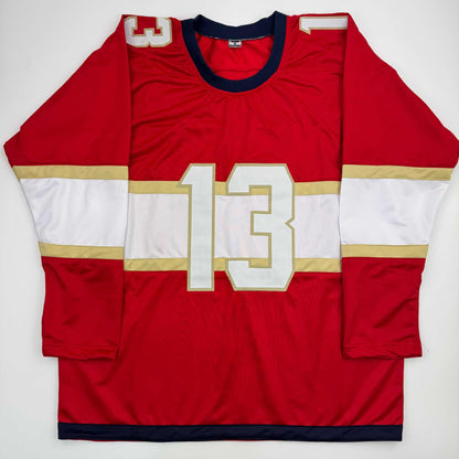 Red and white hockey jersey with number 13 displayed flat against white background, front view.