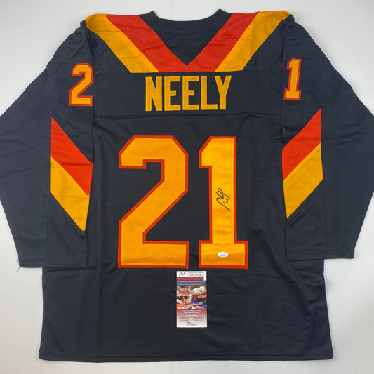 Back view of signed black hockey jersey with "NEELY" and number 21 in yellow and red, featuring diagonal striping and JSA authentication label.