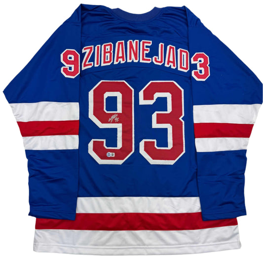 Back view of blue hockey jersey with red and white stripes, displaying "9 ZIBANEJAD 3" and number 93 in red with white outline.