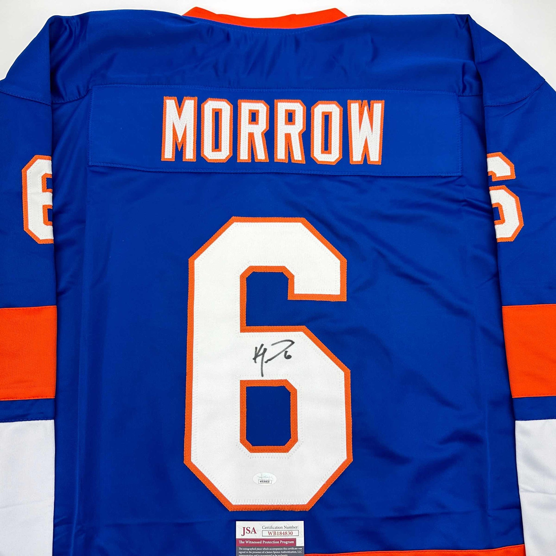 Back view of blue hockey jersey displaying "MORROW" and number 6 with signature, orange and white trim, JSA authentication label visible at bottom.