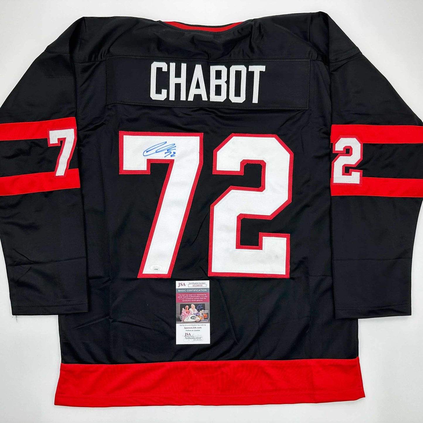 Back view of black hockey jersey number 72 with red and white trim, "CHABOT" nameplate, and JSA authentication certificate visible.