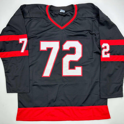 Black and red hockey jersey with white number 72 displayed flat against white background, showing front view with V-neckline and red horizontal stripes on sleeves and hem.