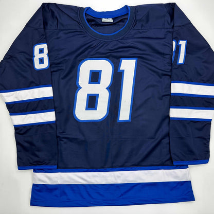 Navy blue hockey jersey with white and blue striping on sleeves, displaying large white "81" numerals on front and smaller numbers on shoulders.