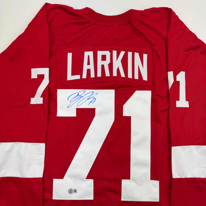 Red Detroit Red Wings hockey jersey displaying "LARKIN" and number 71 with blue autograph signature on white chest panel.