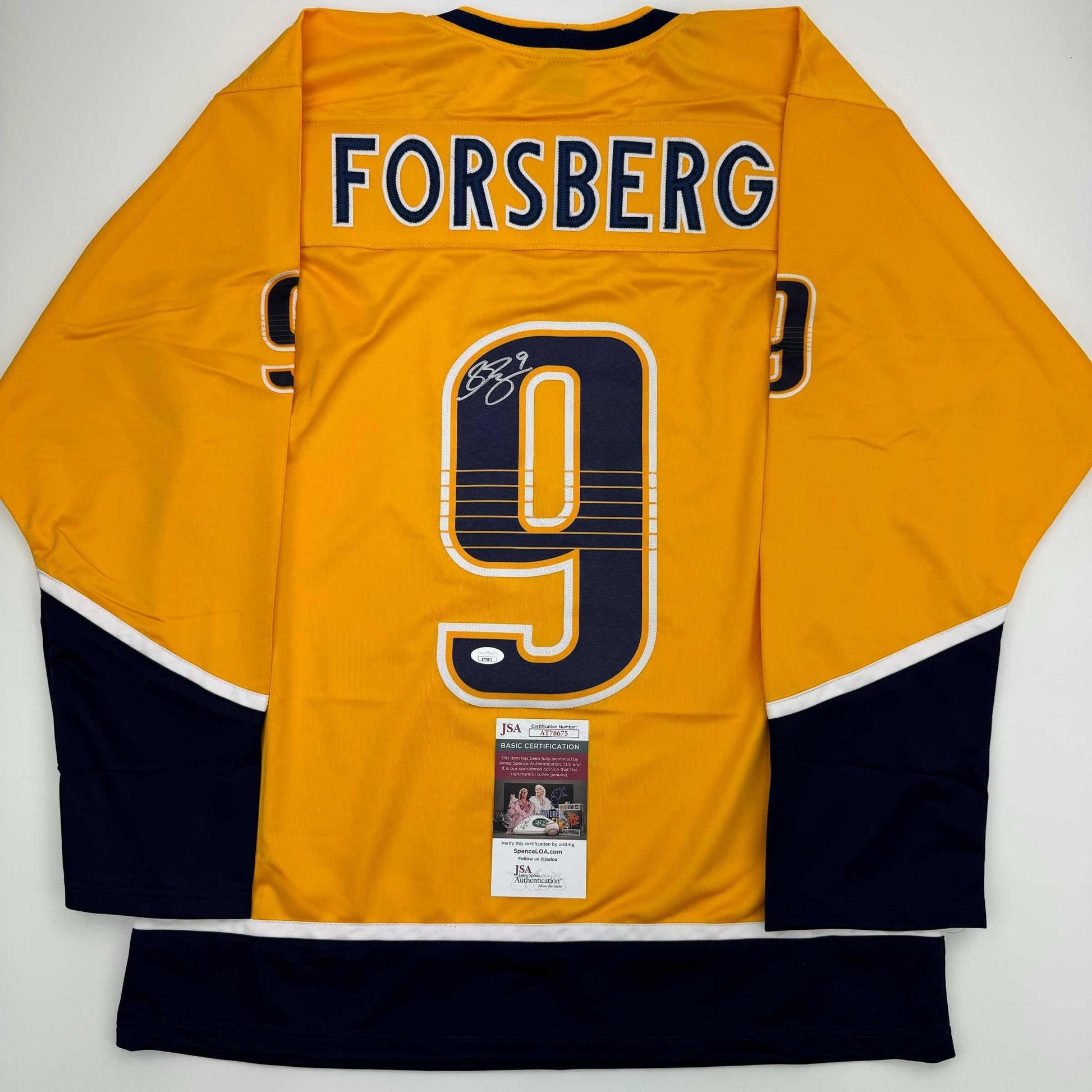 Back view of yellow NHL hockey jersey displaying "FORSBERG" and number 9 with JSA authentication certificate attached.