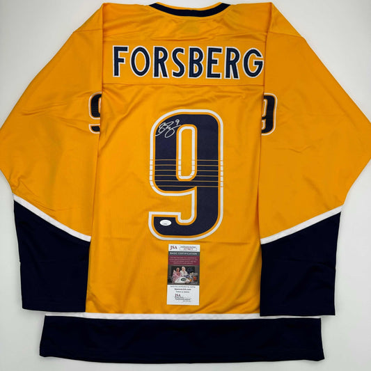 Back view of yellow NHL hockey jersey displaying "FORSBERG" and number 9 with JSA authentication certificate attached.