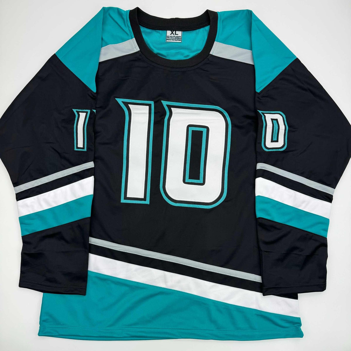 Flat lay of black hockey jersey with turquoise and white striping and large white "10" number on chest.