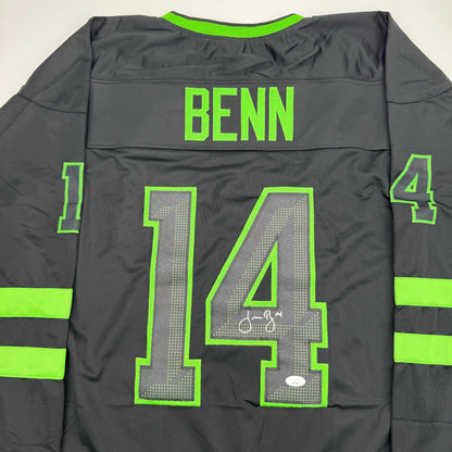 Back view of black hockey jersey with neon green trim, number 14, "BENN" nameplate, and autographed signature on mesh chest panel.