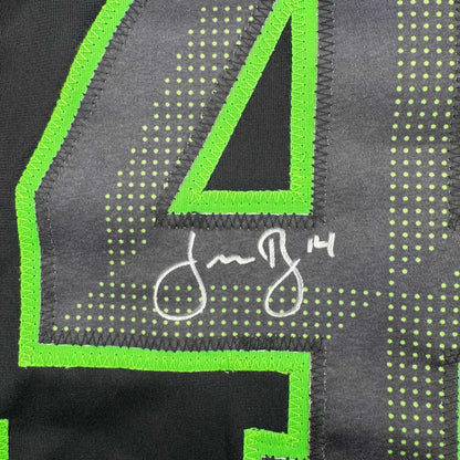 Close-up of neon green embroidered binding and mesh fabric detail on black hockey jersey with dotted pattern.