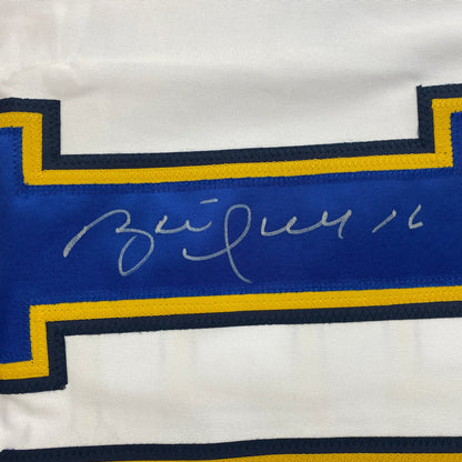 Close-up of Brett Hull's handwritten signature in silver ink on blue jersey stripe with navy and gold trim.