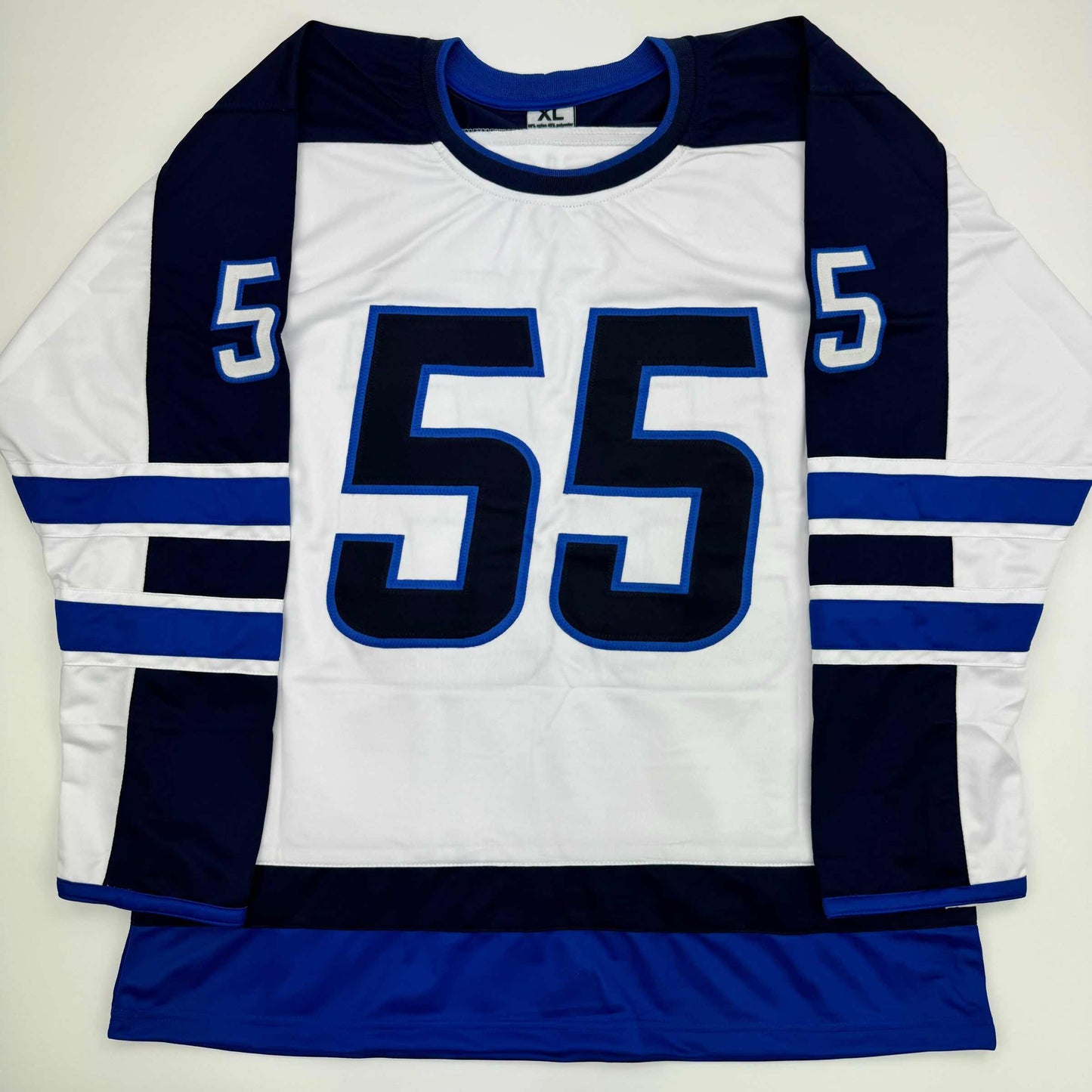 White hockey jersey with navy blue and royal blue stripes, large number 55 centered on chest, displayed flat against neutral background.