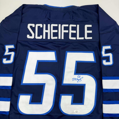 Back view of navy blue hockey jersey with white "SCHEIFELE" nameplate and large white number 55 with blue trim, featuring signature on chest.