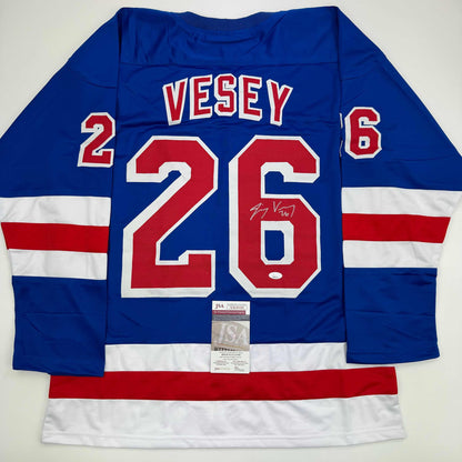 Blue hockey jersey with red and white stripes, displaying "VESEY" and number "26" with JSA authentication certificate attached.