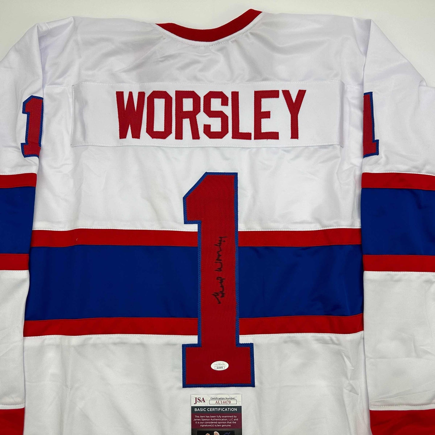 Back view of white Montreal Canadiens hockey jersey number 1 with "WORSLEY" nameplate and signature, featuring red and blue horizontal stripes with JSA authentication certificate visible at bottom.