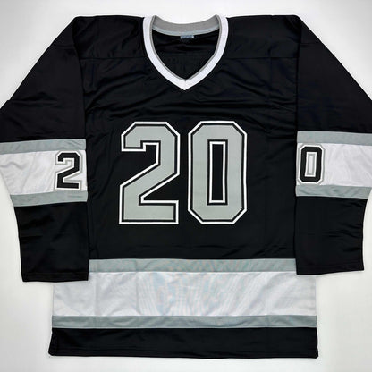 Black and white striped hockey jersey with number 20 displayed flat on white background, front view.