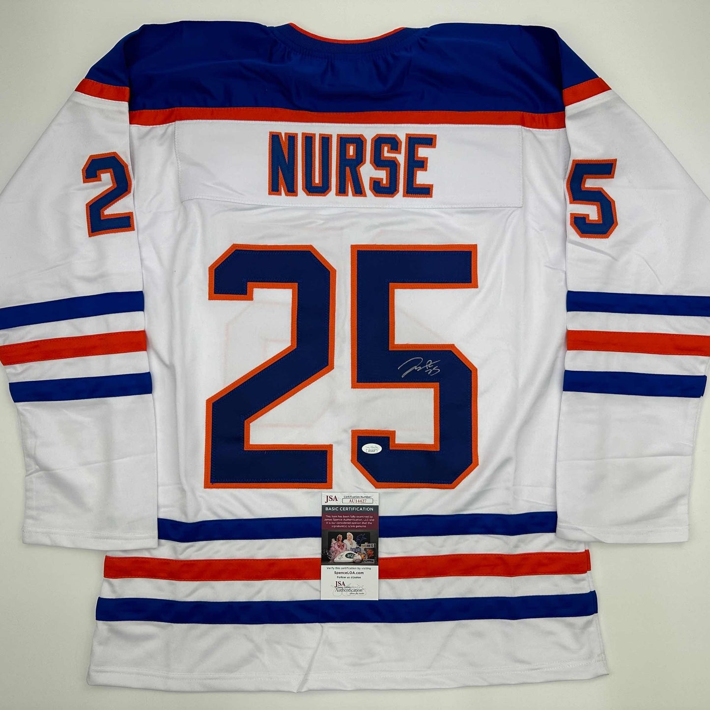Back view of white Edmonton Oilers hockey jersey number 25 with "NURSE" nameplate and JSA authentication certificate visible.