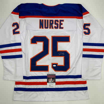 Back view of white Edmonton Oilers hockey jersey number 25 with "NURSE" nameplate and JSA authentication certificate visible.