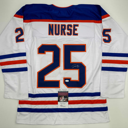 Back view of white Edmonton Oilers hockey jersey number 25 with "NURSE" nameplate and JSA authentication certificate visible.
