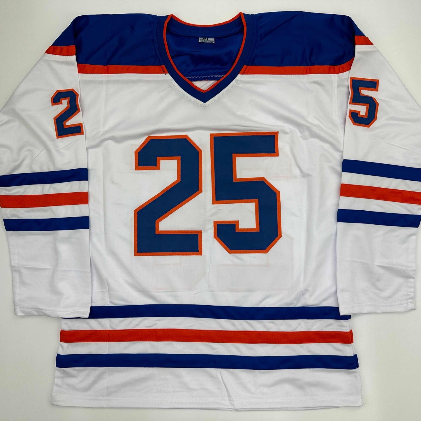 White Edmonton Oilers hockey jersey with navy and orange number 25 displayed flat, front view.