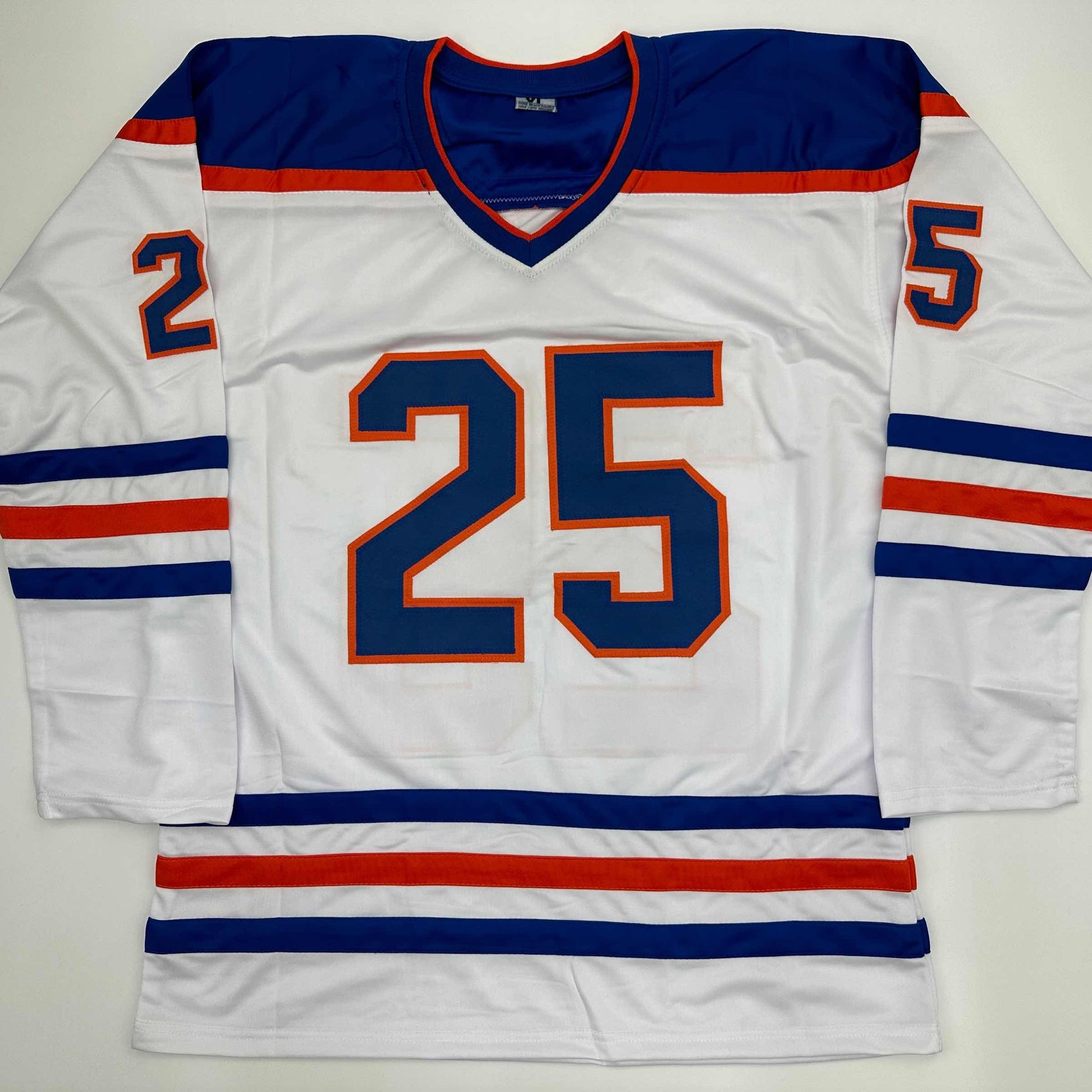 White Edmonton Oilers hockey jersey with navy and orange number 25 displayed flat, front view.