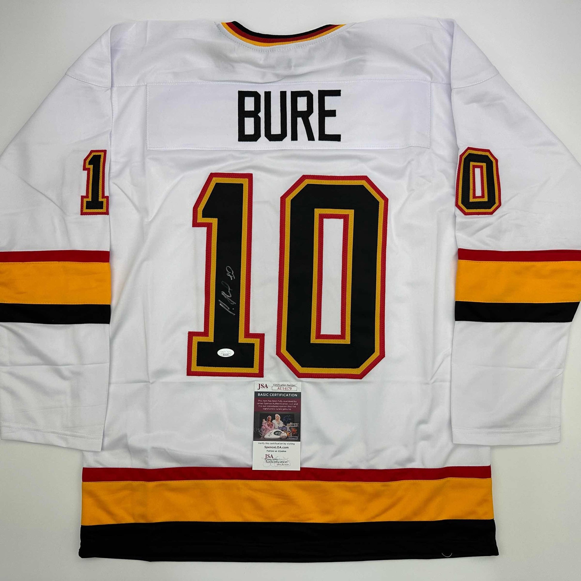 White hockey jersey with "BURE" and number 10 displayed back, signed, with JSA authentication label visible.