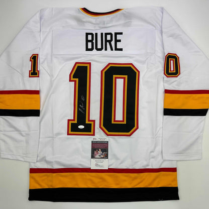 White hockey jersey with "BURE" and number 10 displayed back, signed, with JSA authentication label visible.