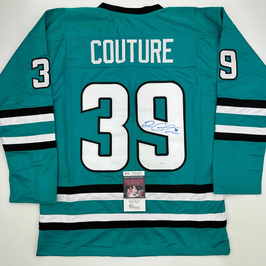 Back view of teal hockey jersey number 39 with "COUTURE" name, white stripes, and JSA authentication certificate visible.