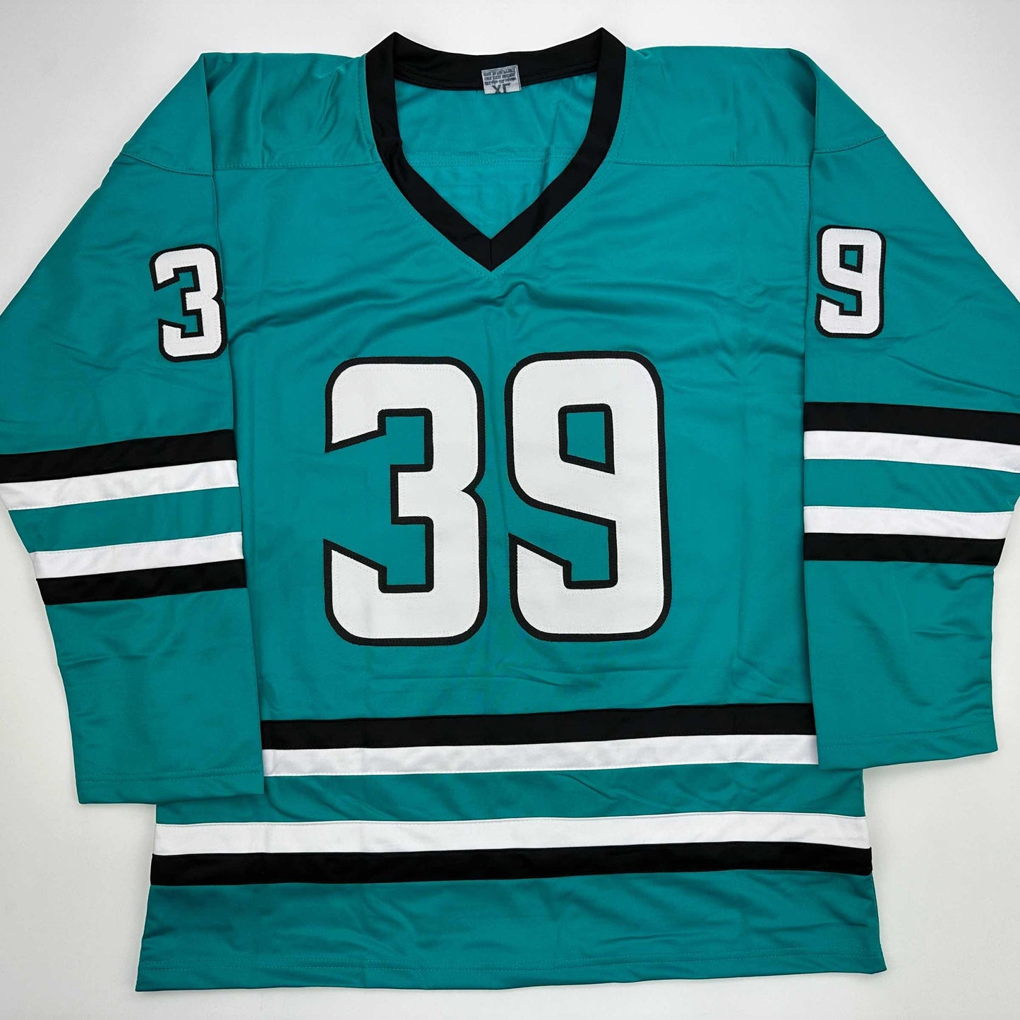 Teal hockey jersey with white and black striped sleeves, displaying number 39 on chest and numbers 3 and 9 on shoulders, laid flat against white background.