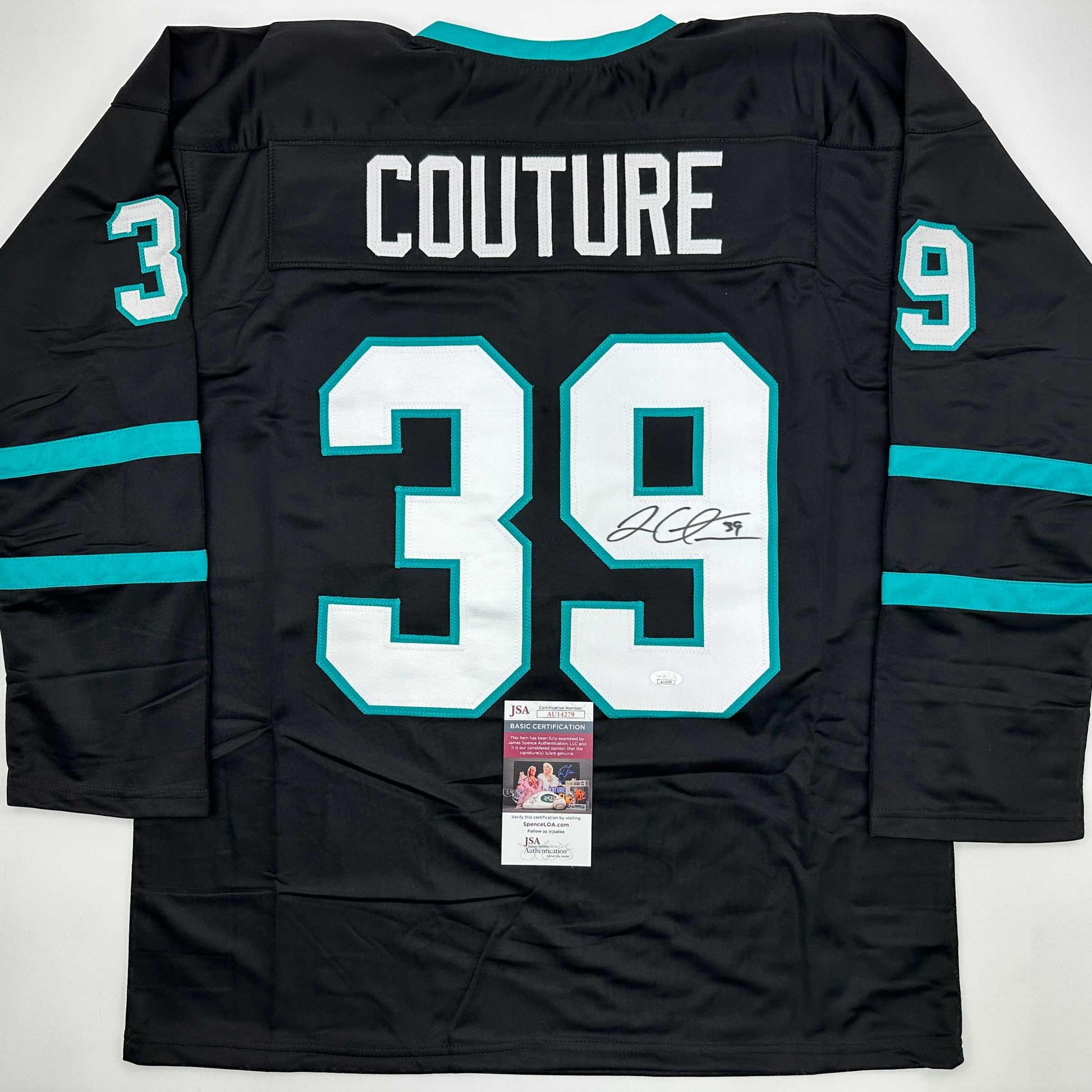 Back view of black hockey jersey with turquoise trim, displaying "COUTURE" and number 39 in white with signature and JSA authentication certificate.