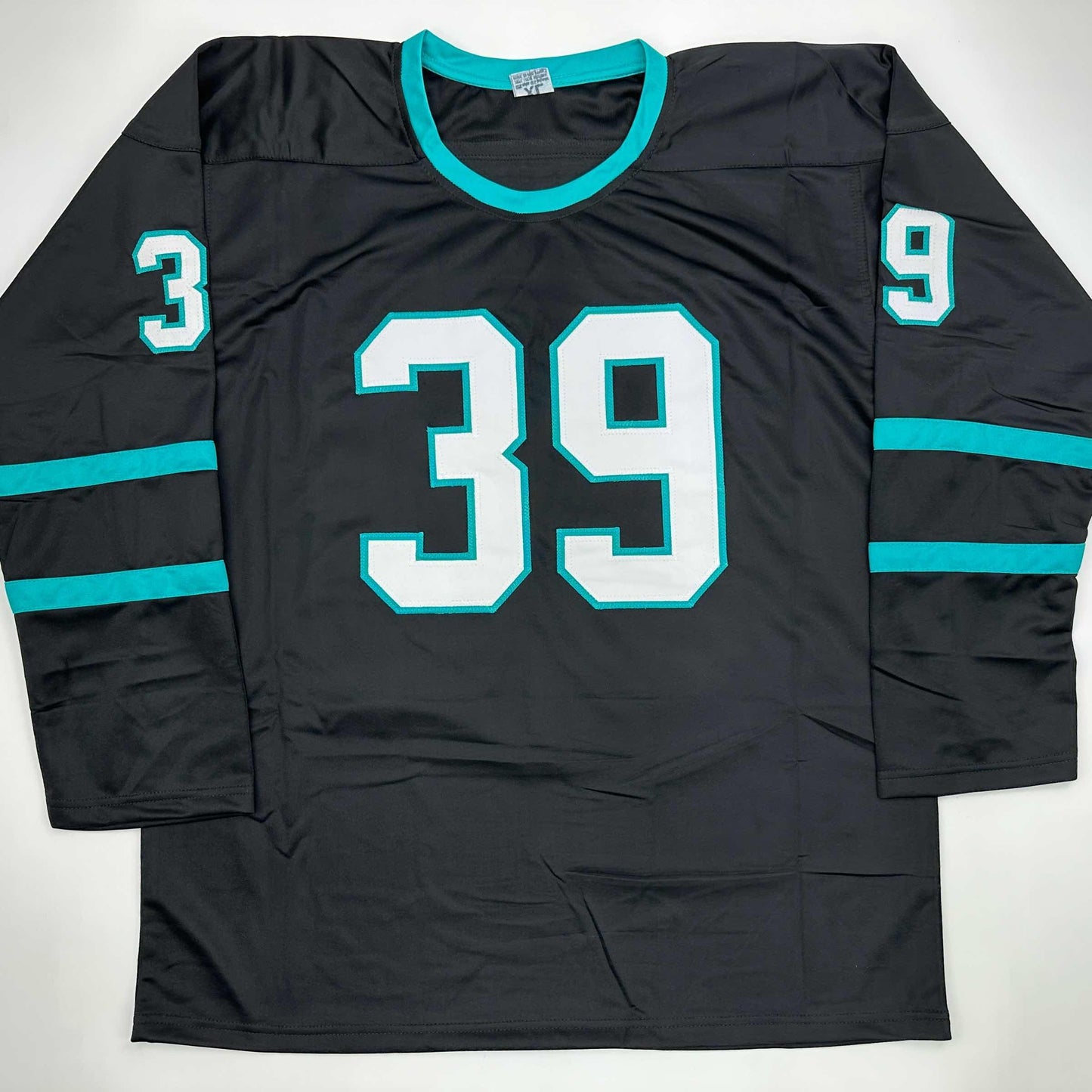 Black hockey jersey with turquoise trim and numbering, displayed flat showing front view with number 39 centered.