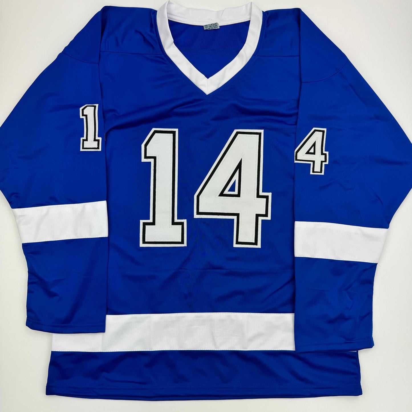 Blue hockey jersey with white stripes and large white numbers "14" displayed flat against white background.