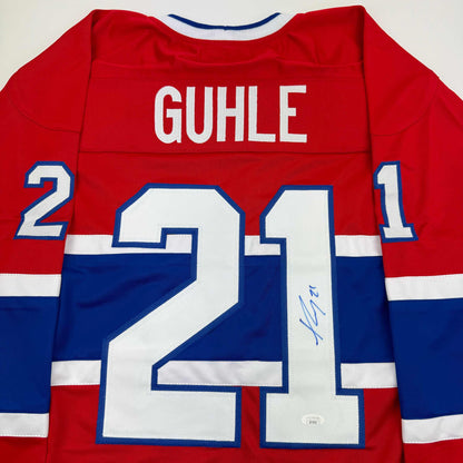 Back view of red and blue Montreal Canadiens hockey jersey number 24 with "GUHLE" nameplate and autographed signature.