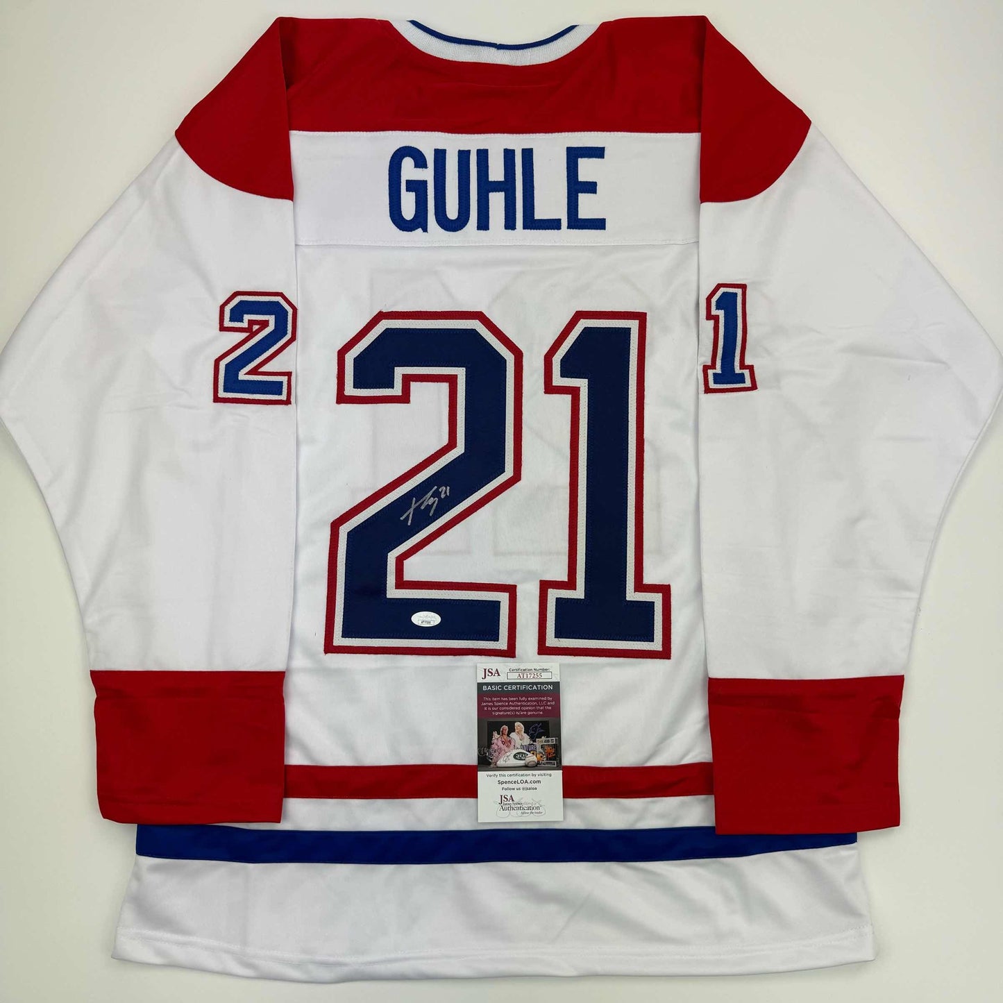 Signed white Montreal Canadiens hockey jersey #21 with "GUHLE" nameplate, displayed flat with JSA authentication certificate visible.