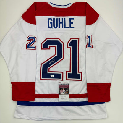 Signed white Montreal Canadiens hockey jersey #21 with "GUHLE" nameplate, displayed flat with JSA authentication certificate visible.