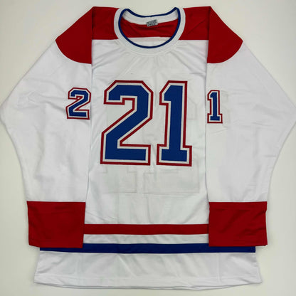 White Montreal hockey jersey with red sleeves and blue trim displaying number 21 on front, laid flat.