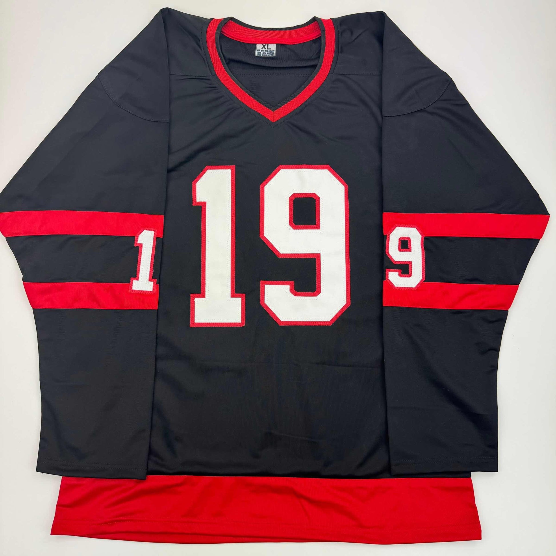 Black and red hockey jersey with white number 19 and red striped sleeves, displayed flat on white background.