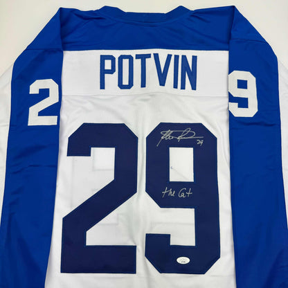 Back view of blue and white signed hockey jersey with "POTVIN" nameplate and number 29, displayed flat against white background.